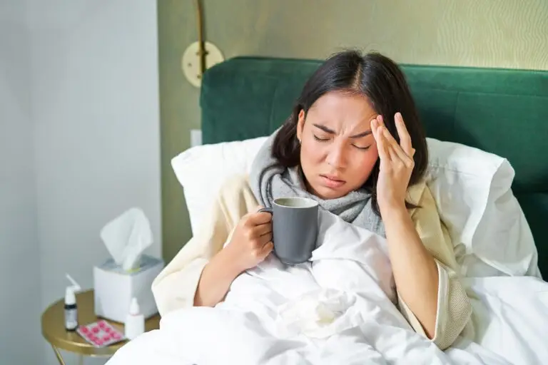 Flu, sickness and people. Young woman feeling sick, having fever and catching col, lying in bed