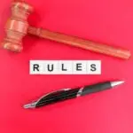 judge's pen and gavel with the word rule.